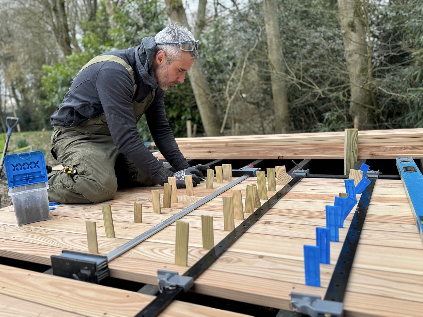 Carpenter laying and spacing new deck boards – USFEW carpentry, Kent
