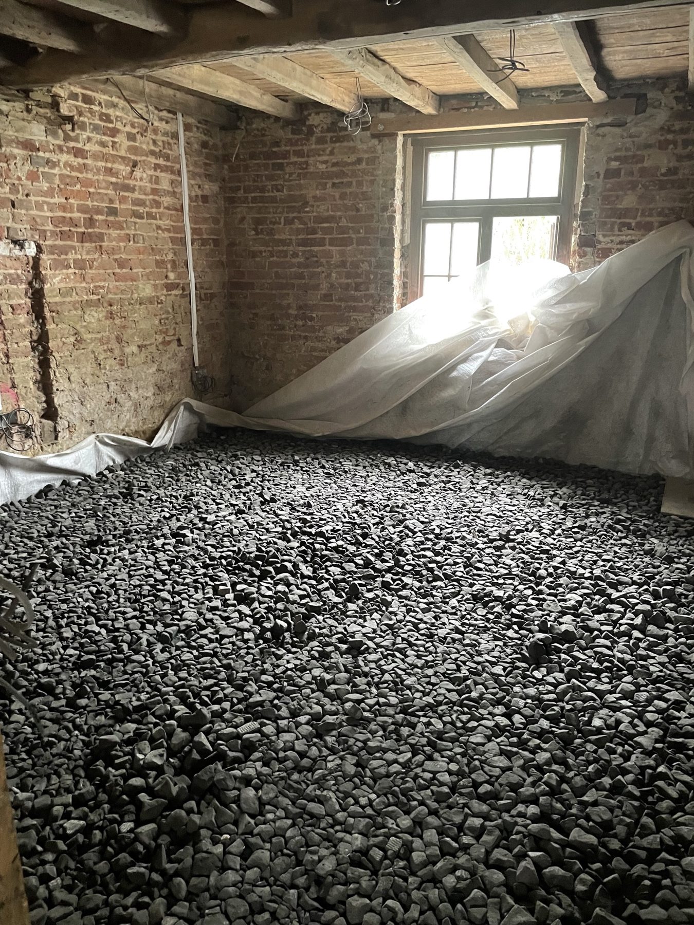 Insulating foamed glass sub-base laid for a limecrete floor in a period home in Kent