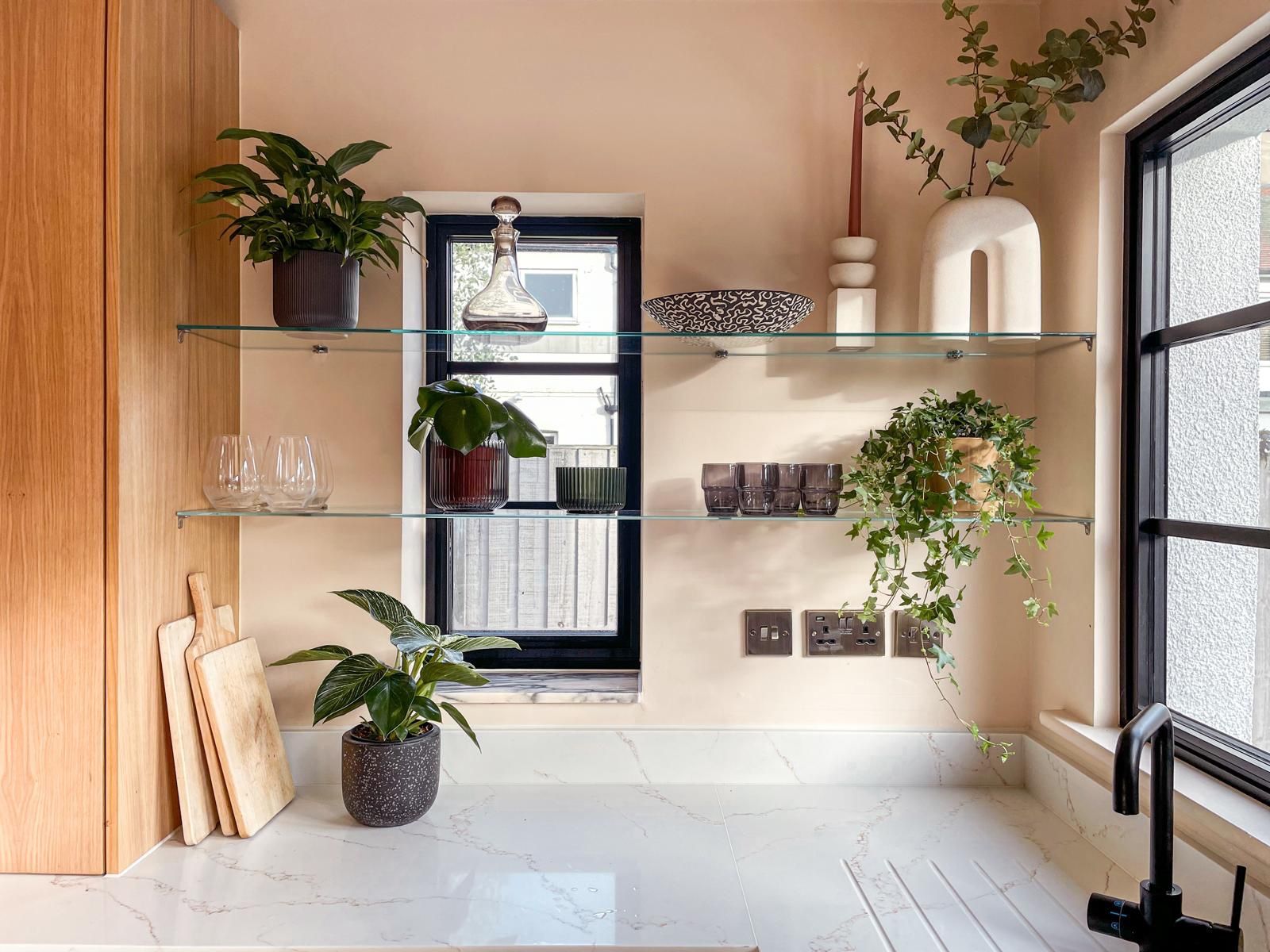 Glass shelving and black-framed window, remodelled kitchen in Kent